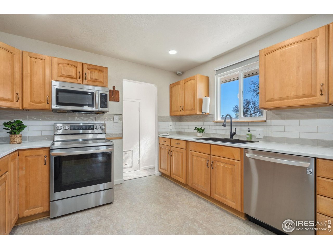 113 Balsam Street Fort Morgan, CO 80701 - Photo 4 of 30 a kitchen with stainless steel appliances a stove microwave and sink