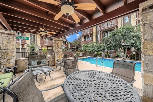 a swimming pool with outdoor seating and yard