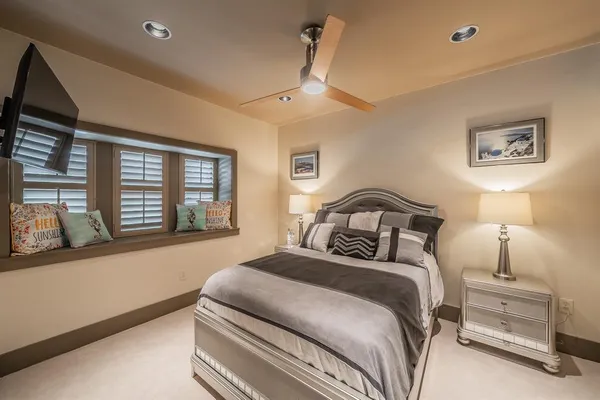 a bedroom with a bed and a large window