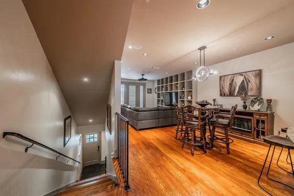 a view of a dining room with furniture and wooden floor