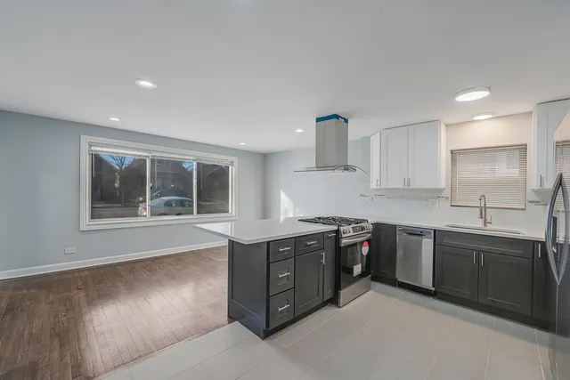 a kitchen with stainless steel appliances granite countertop a sink stove and cabinets