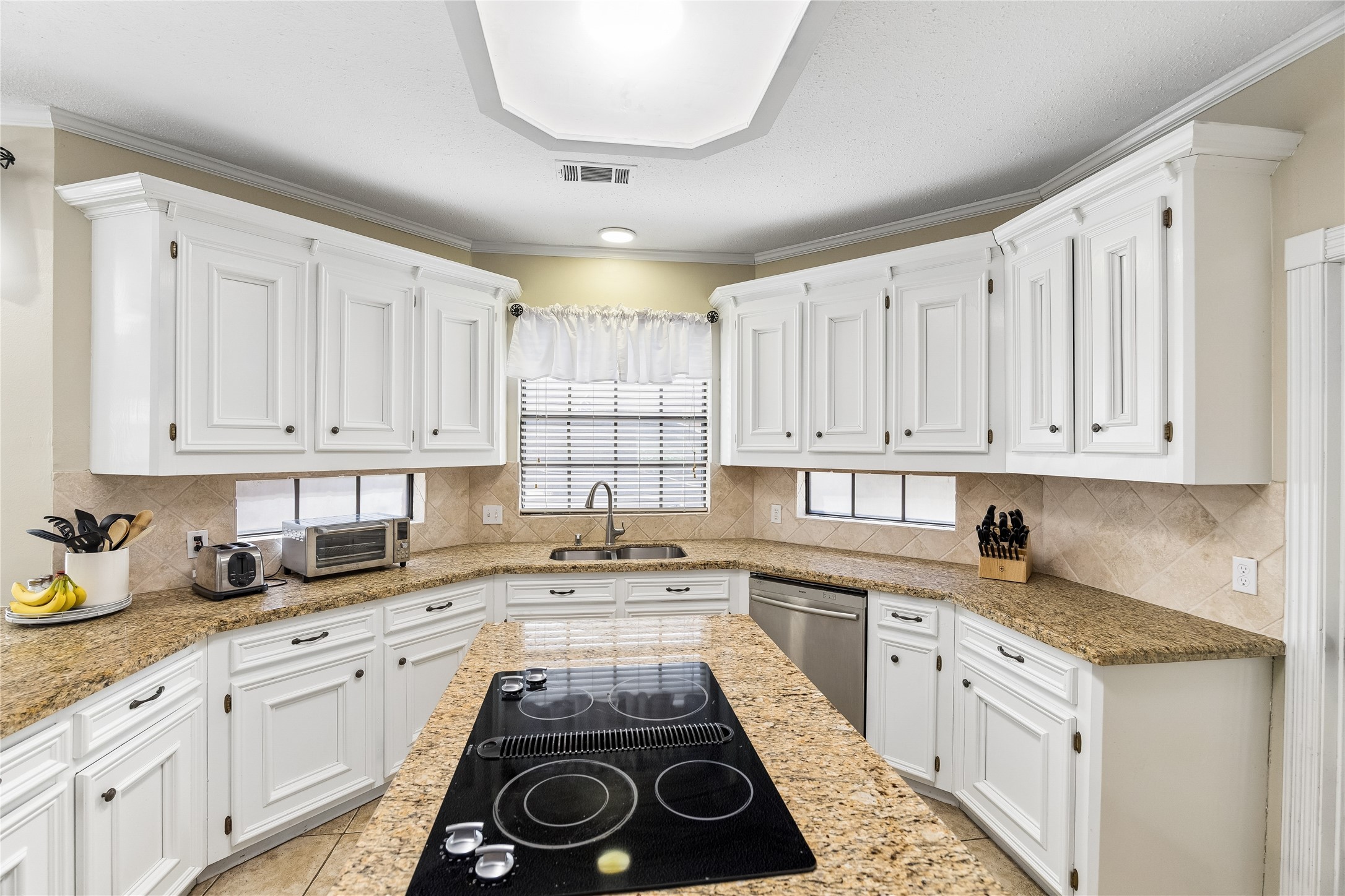 5823 Ashmere Lane Spring, TX 77379 - Photo 11 of 29 a kitchen with a sink stove and cabinets