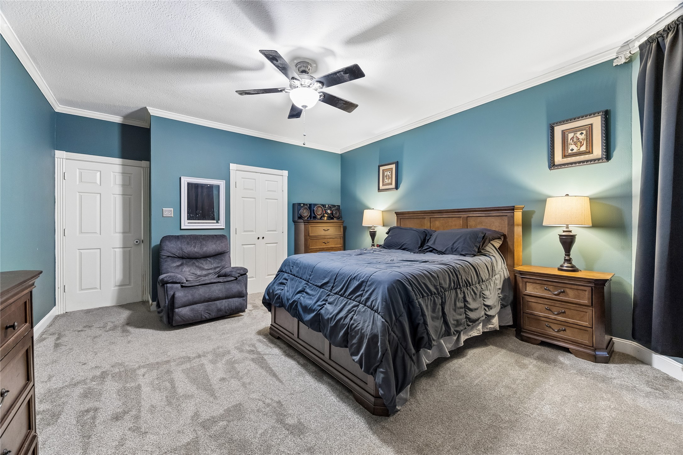 5823 Ashmere Lane Spring, TX 77379 - Photo 14 of 29 a spacious bedroom with a bed and wooden floor