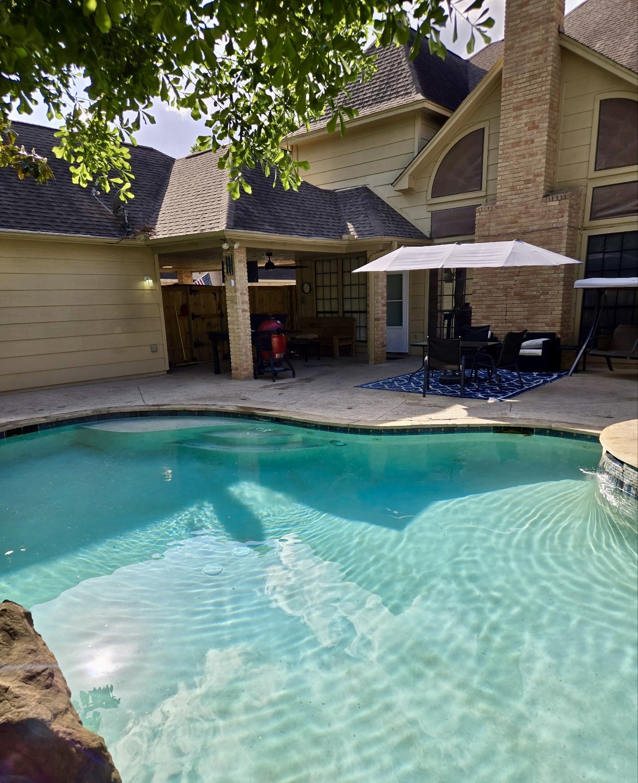5823 Ashmere Lane Spring, TX 77379 - Photo 25 of 29 a patio with table and chairs under an umbrella