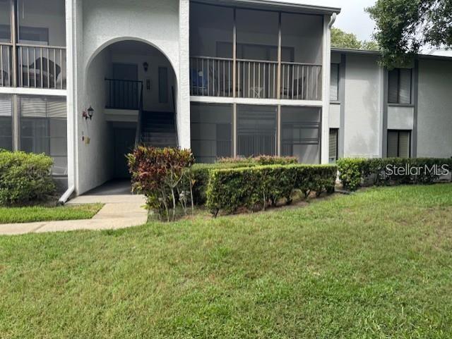1258 Pine Ridge Circle West, Unit F1 Tarpon Springs, FL 34688 - Photo 1 of 1 a front view of a house with garden
