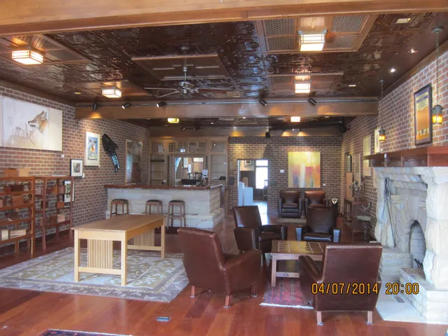 a living room with furniture a fireplace and a table