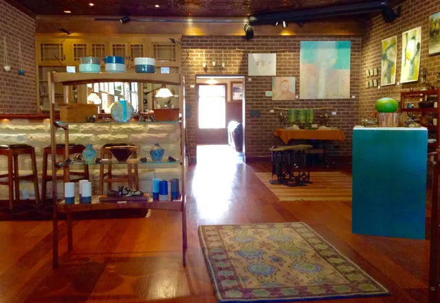 a living room with fireplace furniture and a potted plant