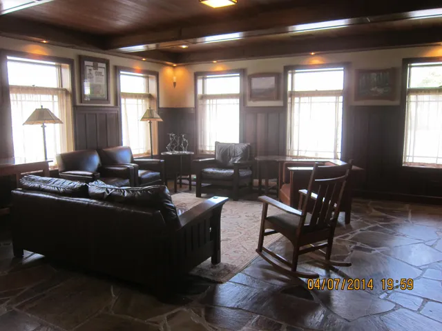 a living room with furniture window and wooden floor