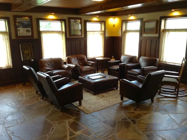 a living room with furniture rug and a window