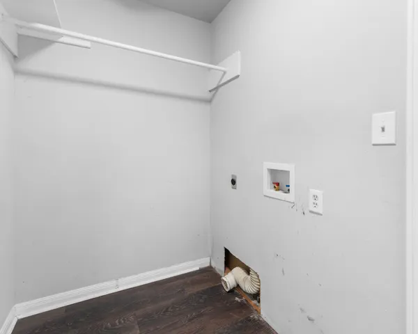 a view of a hallway with wooden floor and a living room