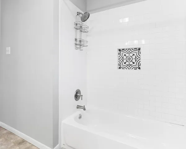 a view of room with window and a ceiling fan