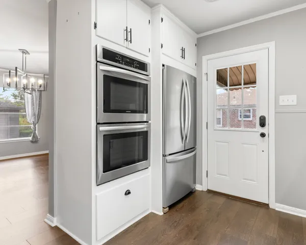 a kitchen with stainless steel appliances a refrigerator stove and microwave
