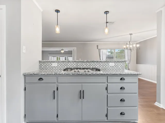 a bathroom with a granite countertop sink vanity and mirror