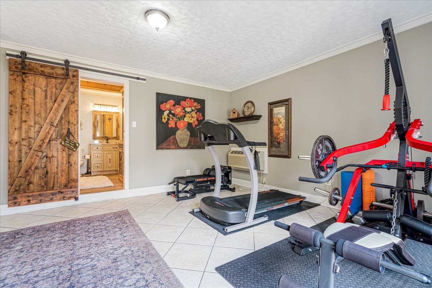 9516 El Hill Road Lakeland, TN 38002 - Photo 14 of 25 a living room with furniture gym equipment and a flat screen tv