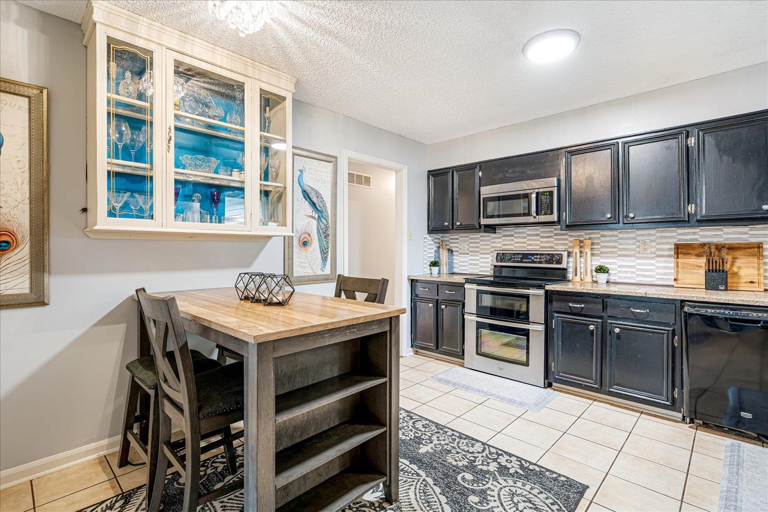 9516 El Hill Road Lakeland, TN 38002 - Photo 6 of 25 a kitchen with stainless steel appliances stove microwave and refrigerator