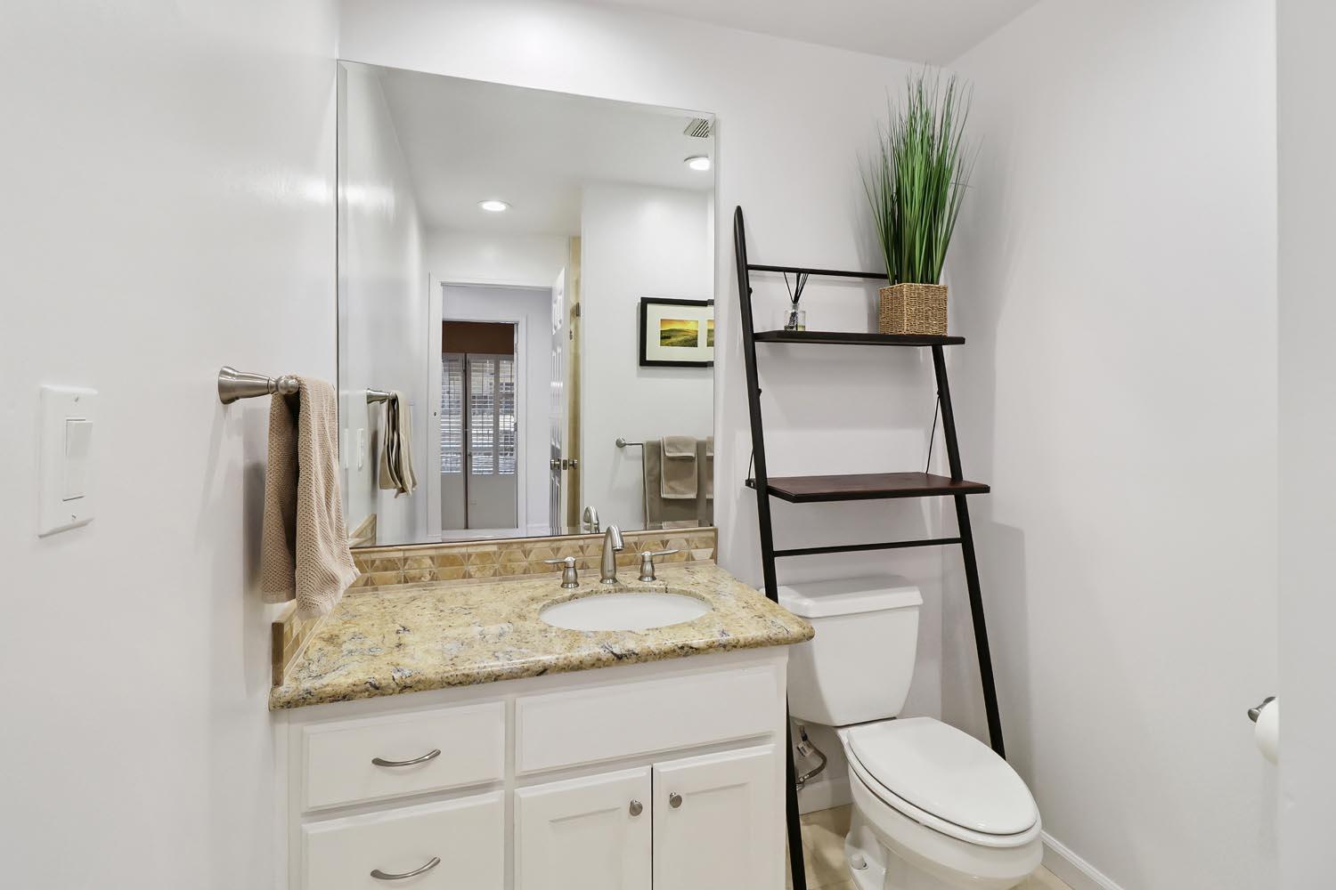 51 Covered Bridge Road Carmichael, CA 95608 - Photo 20 of 86 a bathroom with a granite countertop sink toilet and mirror