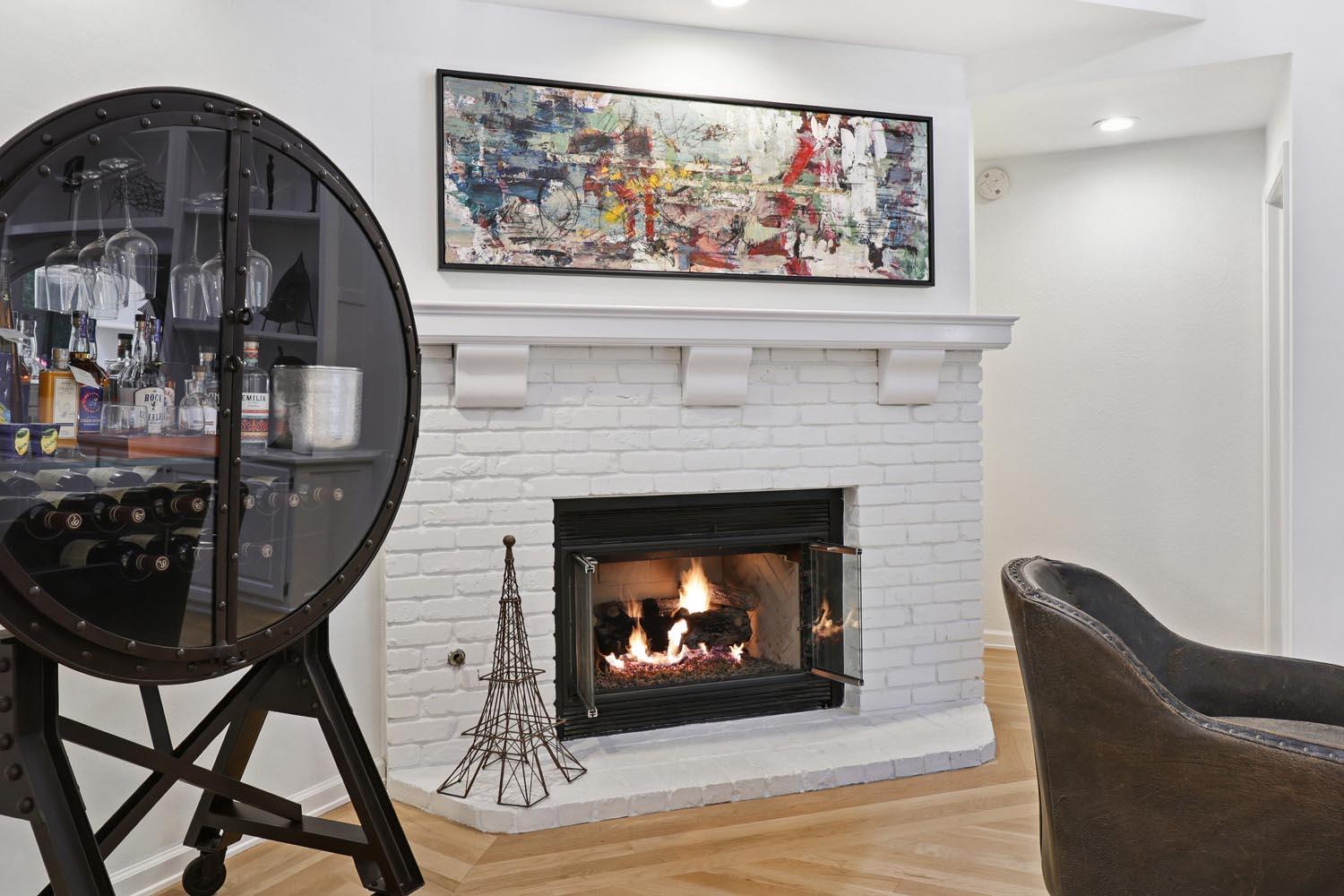 51 Covered Bridge Road Carmichael, CA 95608 - Photo 34 of 86 a living room with a fireplace and a painting on the wall