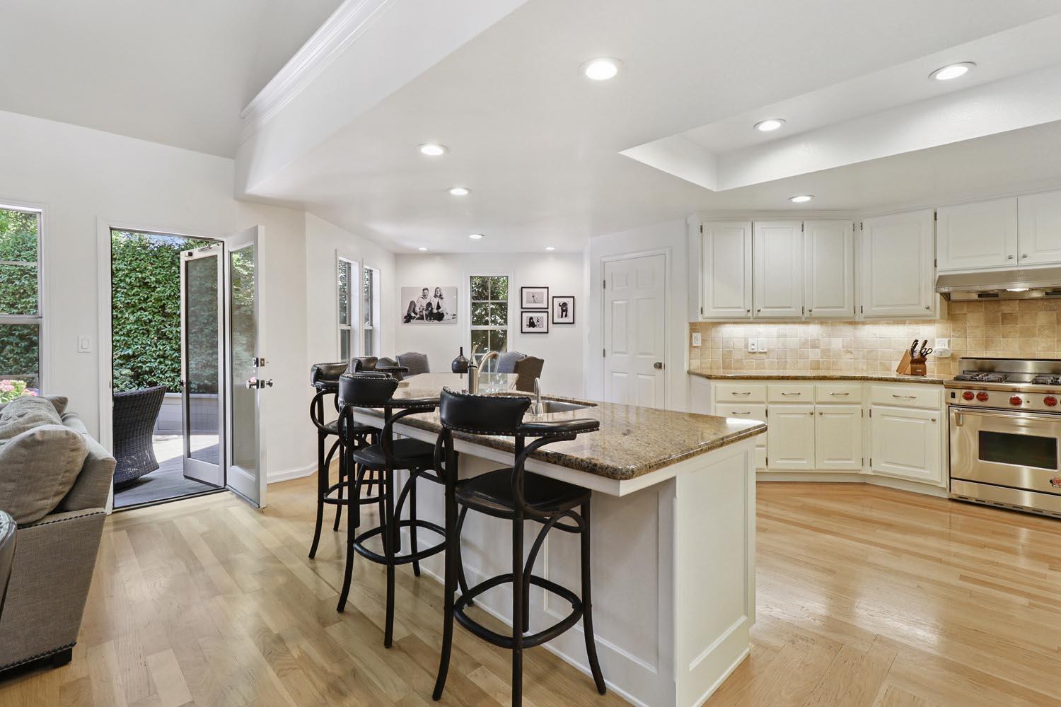 51 Covered Bridge Road Carmichael, CA 95608 - Photo 41 of 86 a kitchen with stainless steel appliances kitchen island granite countertop a table chairs sink and cabinets