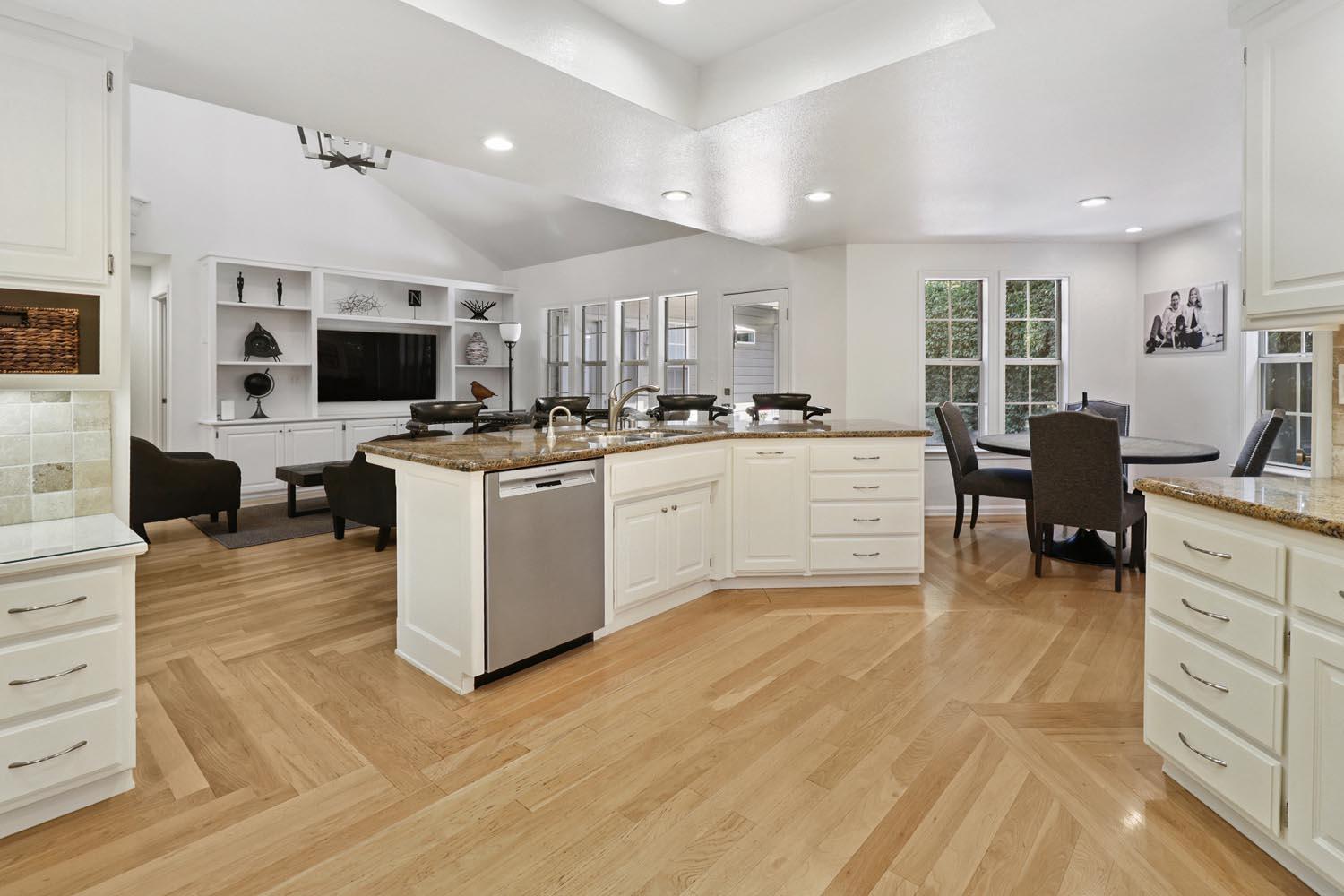51 Covered Bridge Road Carmichael, CA 95608 - Photo 46 of 86 a large white kitchen with cabinets and chairs