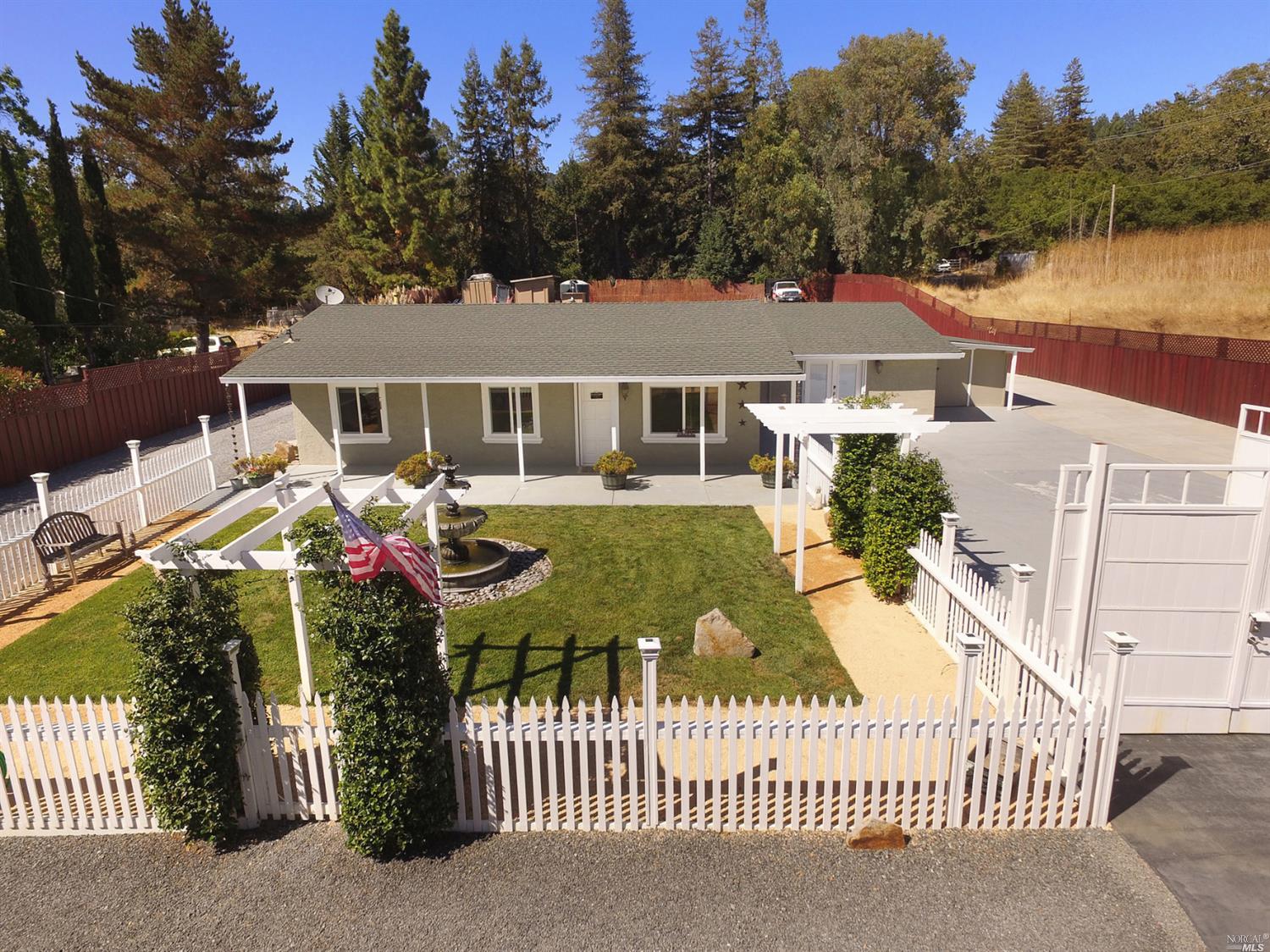 a view of a house with backyard and sitting area