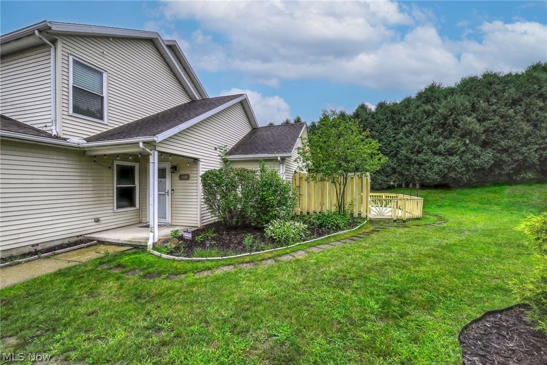 5203 Cline Road Kent, OH 44240 - Photo 5 of 35 Siding exterior with multiple rooflines, a concrete patio, and a landscaped garden bed