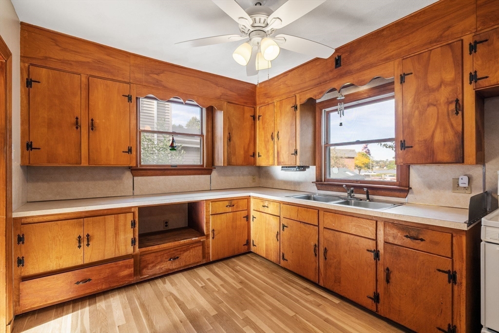 18 Hummock Road Quincy, MA 02171 - Photo 12 of 37 a kitchen with stainless steel appliances granite countertop a sink cabinets and wooden floor