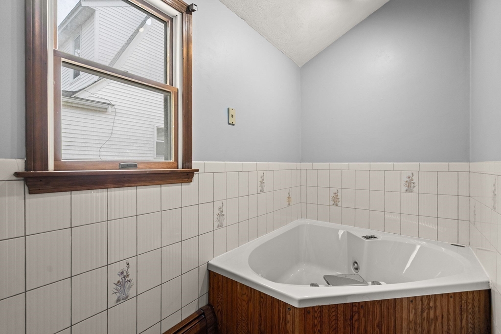 18 Hummock Road Quincy, MA 02171 - Photo 17 of 37 a bathroom with a bathtub