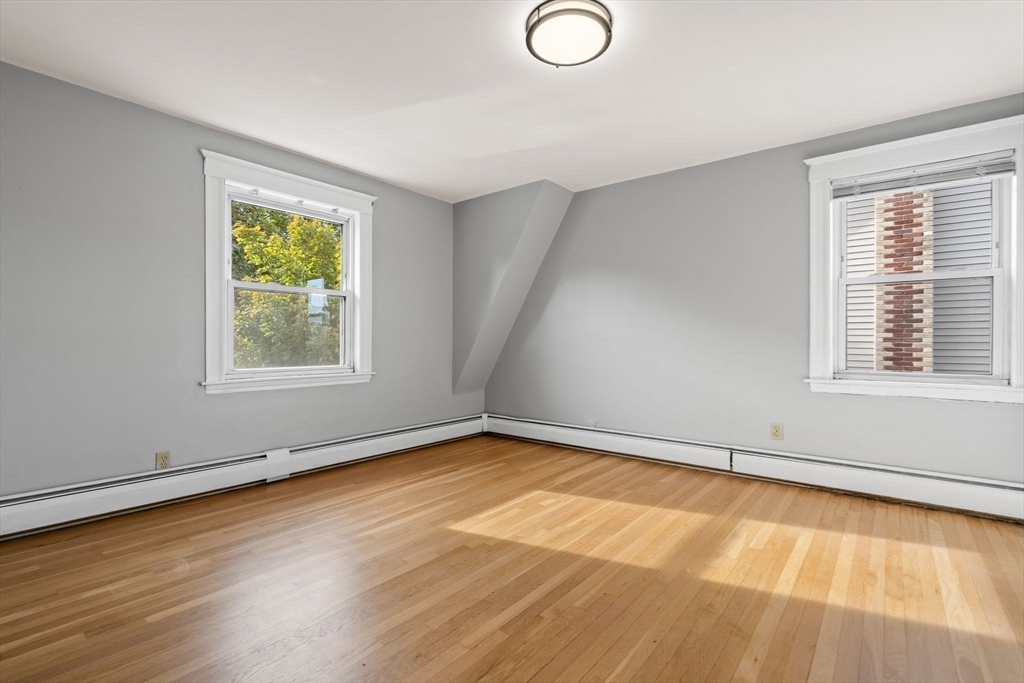18 Hummock Road Quincy, MA 02171 - Photo 22 of 37 a view of an empty room with a window and wooden floor