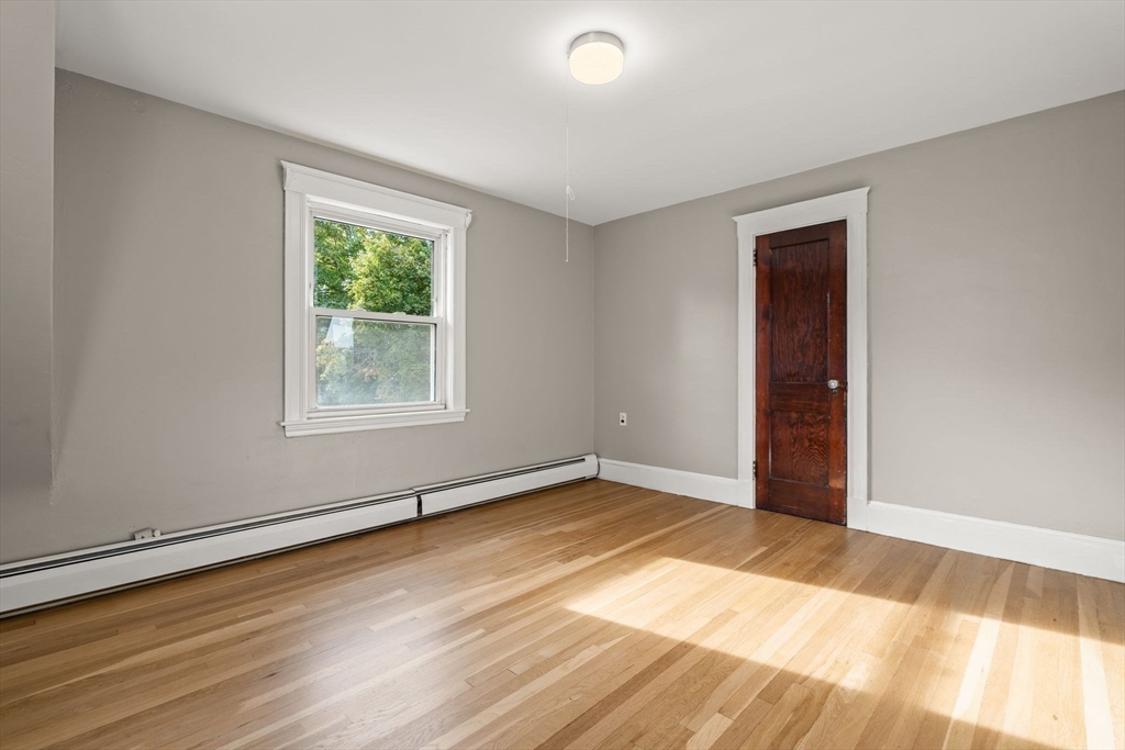 18 Hummock Road Quincy, MA 02171 - Photo 25 of 37 a view of an empty room with wooden floor and a window
