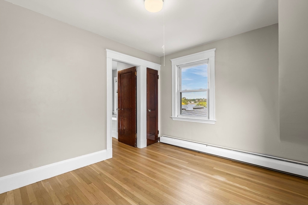 18 Hummock Road Quincy, MA 02171 - Photo 27 of 37 an empty room with wooden floor and windows