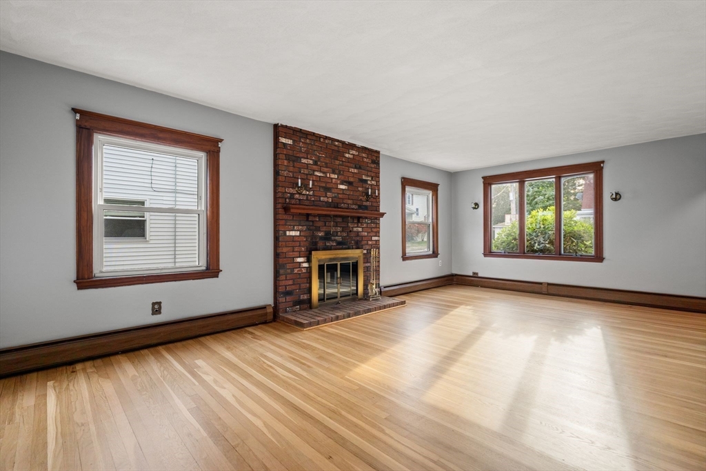18 Hummock Road Quincy, MA 02171 - Photo 5 of 37 a view of an empty room with a window and fireplace