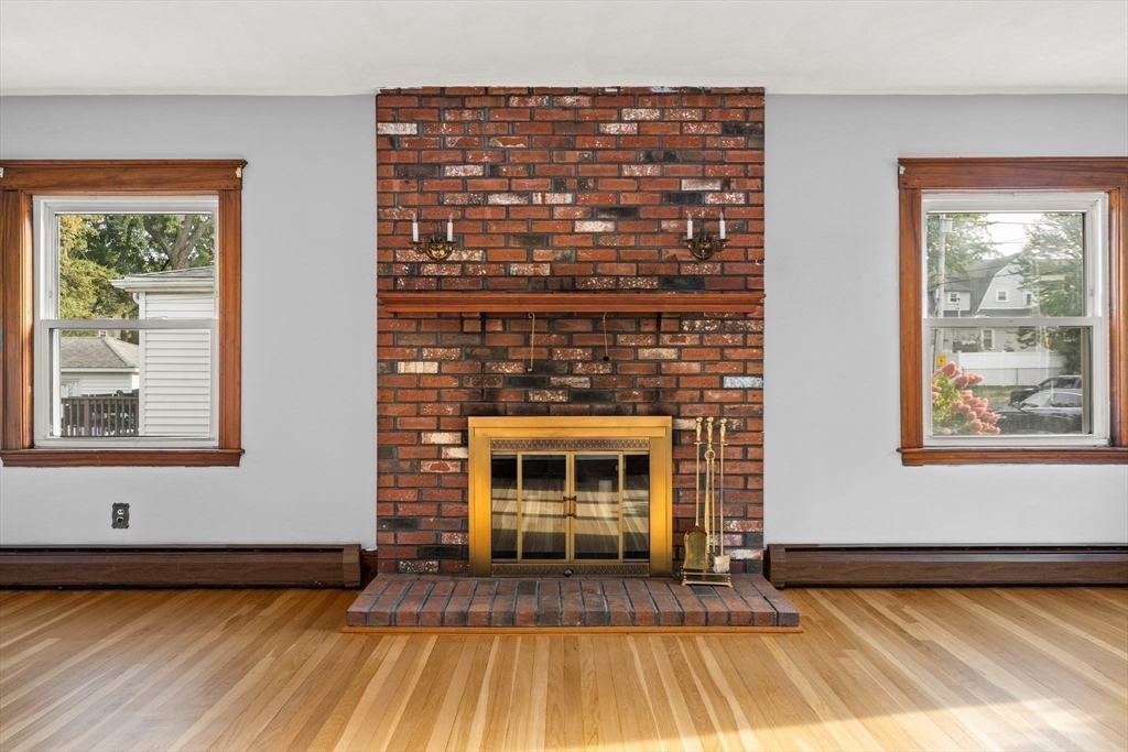 18 Hummock Road Quincy, MA 02171 - Photo 6 of 37 a living room with a fireplace and a wooden floor
