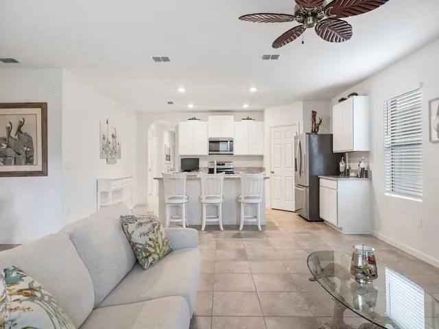 a living room with furniture and kitchen view