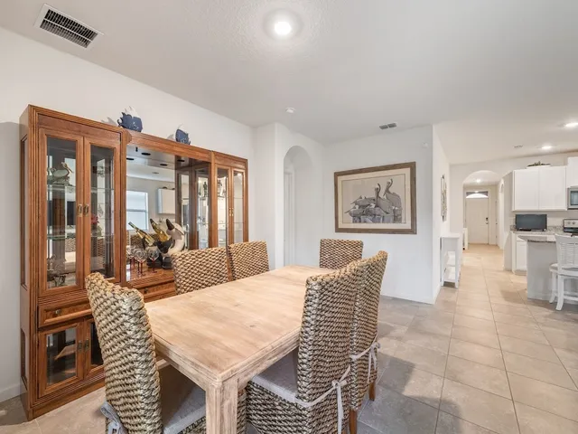 a living room with furniture a large window and potted plants