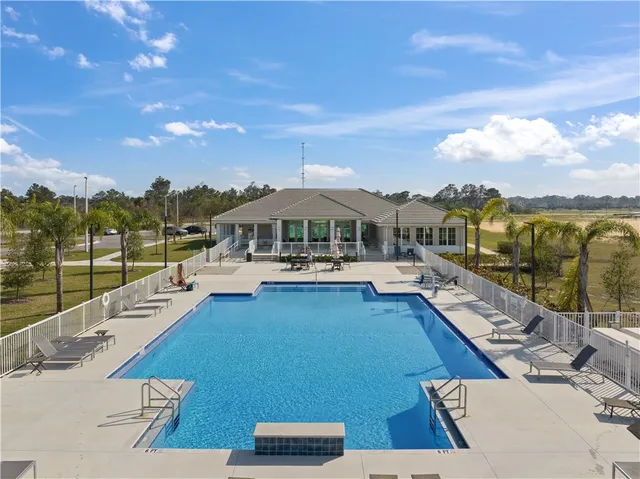 an aerial view of a house with swimming pool and ocean view