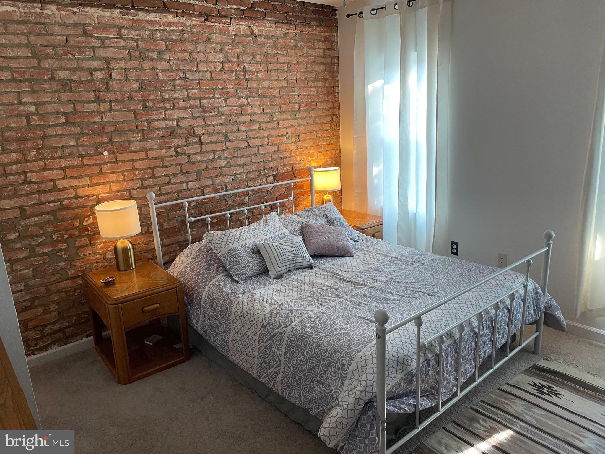 1841 Light Street Baltimore, MD 21230 - Photo 17 of 21 a bed sitting in a bedroom next to a window