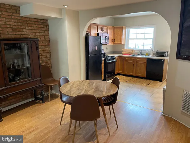 a kitchen with stainless steel appliances granite countertop a stove a sink dishwasher and a refrigerator with wooden floor