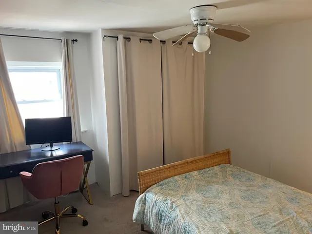 a bedroom with a bed a desk and chair