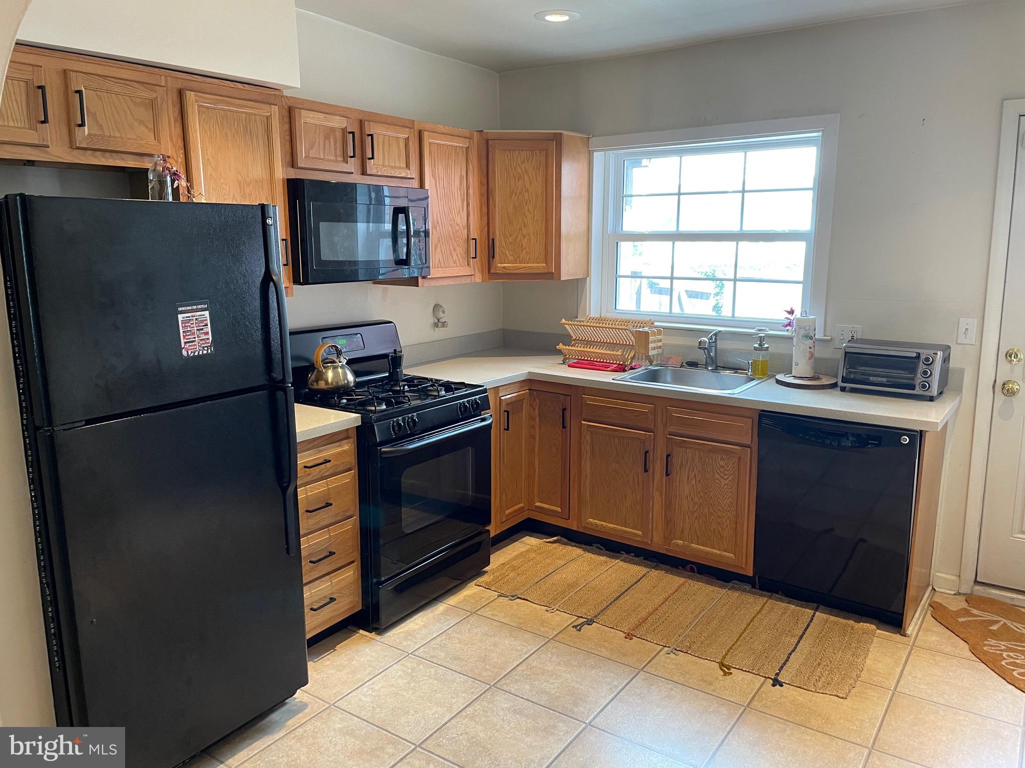 1841 Light Street Baltimore, MD 21230 - Photo 10 of 21 a kitchen with stainless steel appliances granite countertop a refrigerator stove top oven and sink