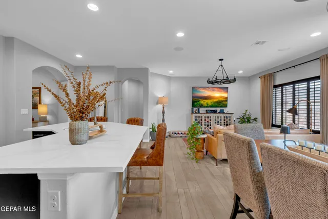 a view of a dining room with furniture and chandelier