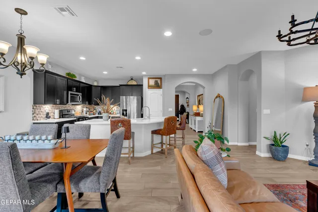 a living room with furniture a chandelier and a window