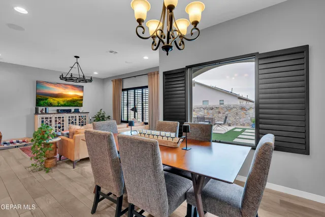 a living room with stainless steel appliances kitchen island granite countertop furniture and a wooden floor