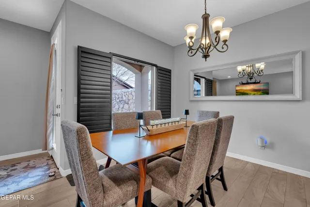 a living room with furniture a chandelier and a flat screen tv