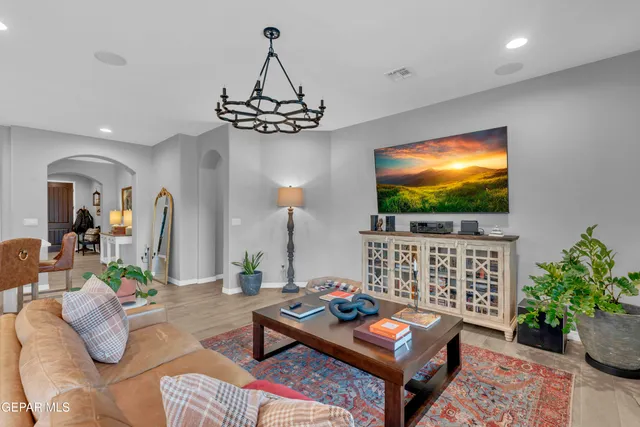 a spacious bedroom with a bed and a chandelier
