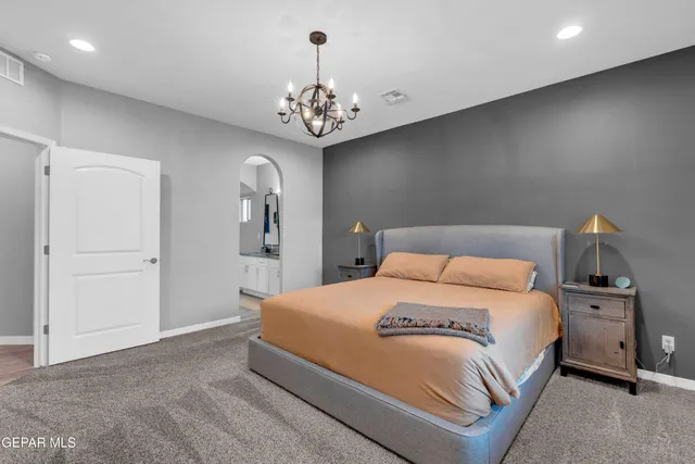 a patio with table and chairs and potted plants