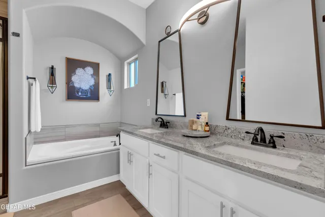 a roof deck with table and chairs