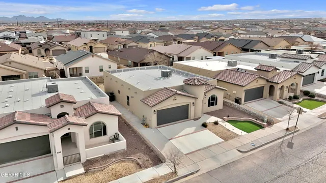 an aerial view of residential houses with outdoor space