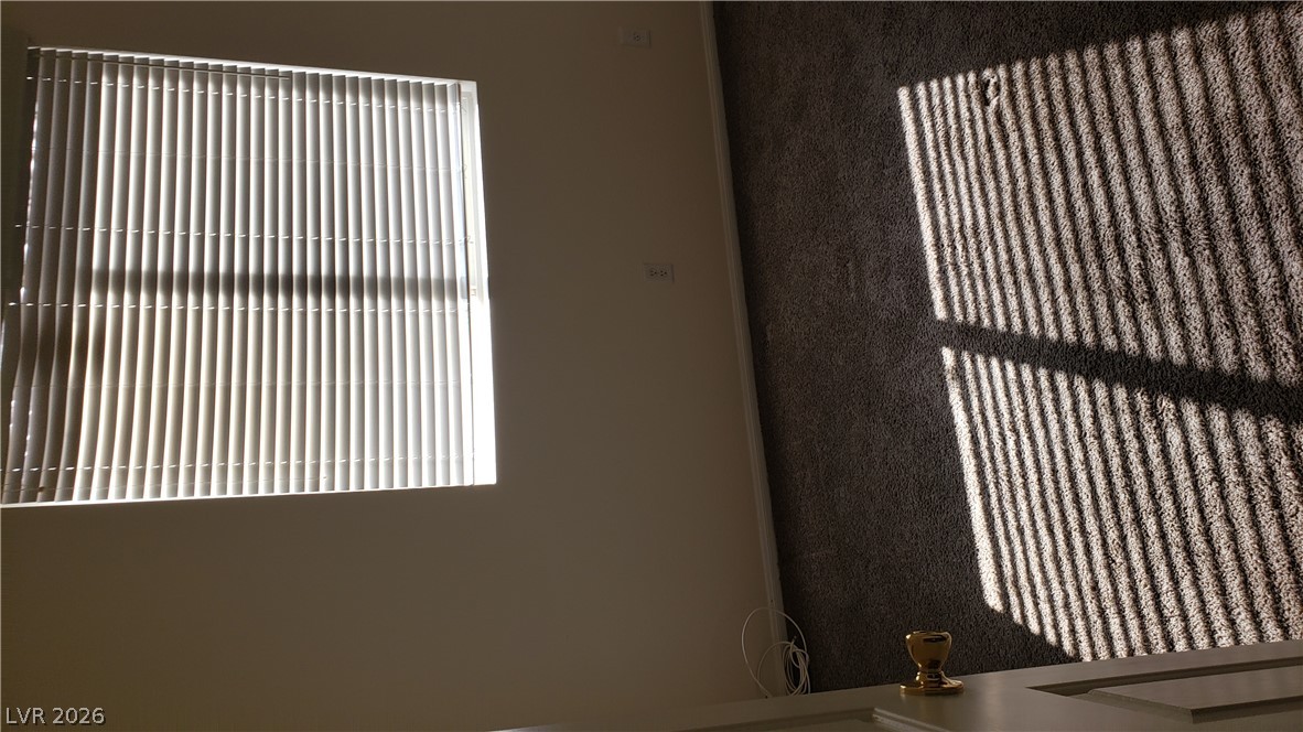 9112 Manalang Road Las Vegas, NV 89123 - Photo 40 of 50 Sunlight streams through window blinds, casting inviting shadows across the plush carpet.