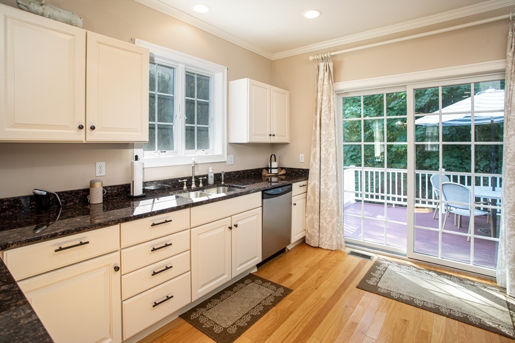 1346 Main Road, Unit B Westport, MA 02790 - Photo 13 of 29 a kitchen with granite countertop a stove a sink and white cabinets