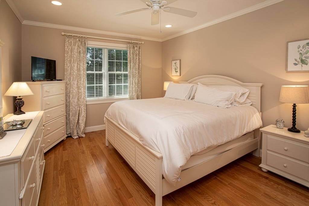 1346 Main Road, Unit B Westport, MA 02790 - Photo 17 of 29 a bedroom with a bed and a flat tv screen on dresser